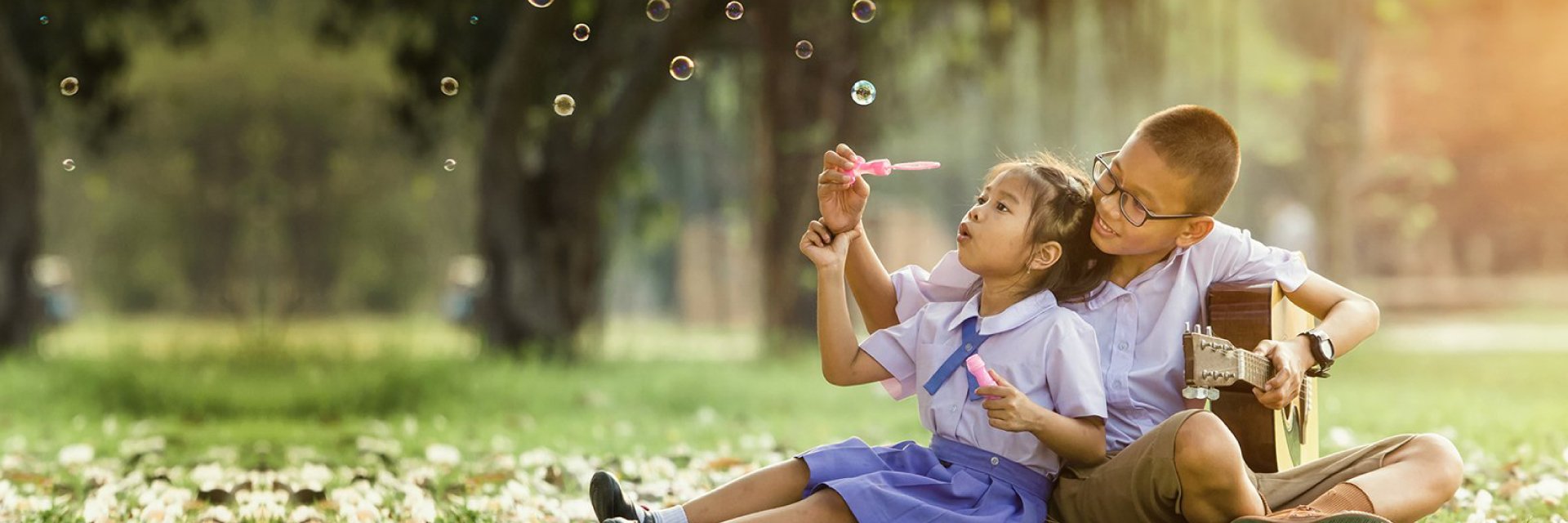 Children blowing bubbles outside