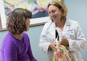 Patient care navigator talking with patient