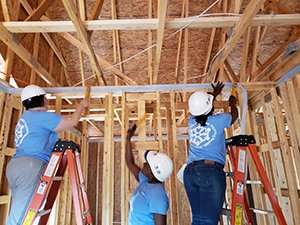 Volunteers help build a Habitat for humanity house