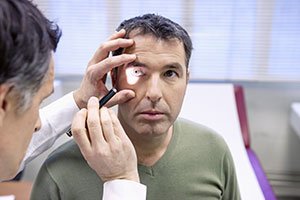 Doctor shining light in patient's eye