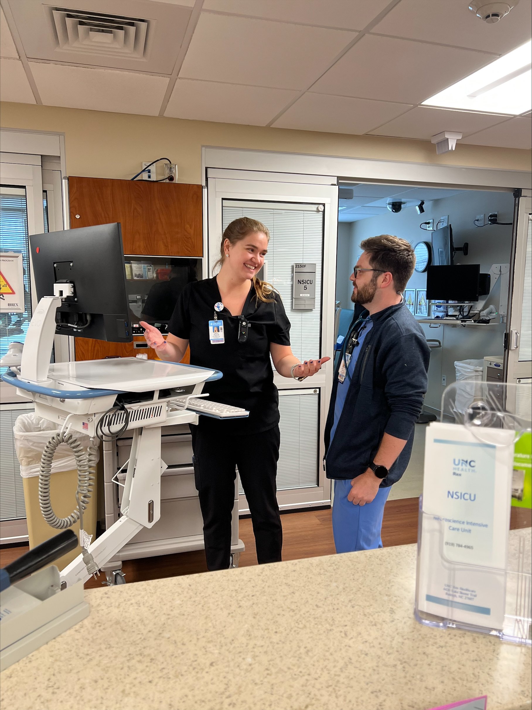 Two PGY2 Team Members discuss in front of a computer